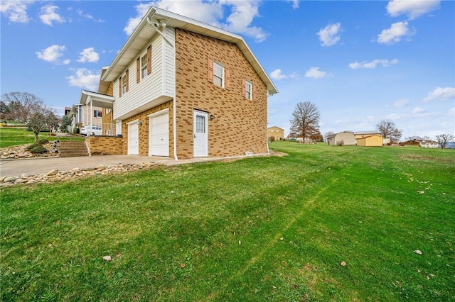 view of side of home with a yard and a garage