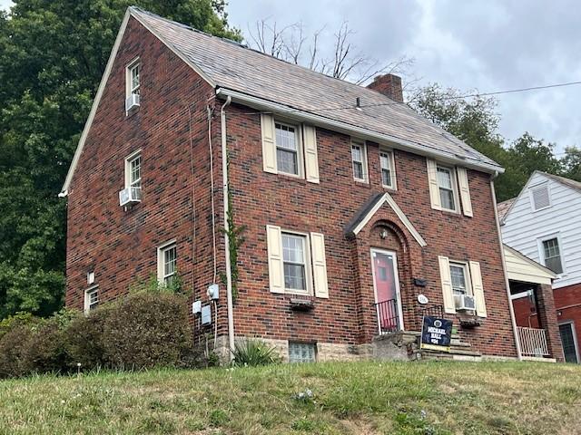 colonial-style house featuring cooling unit