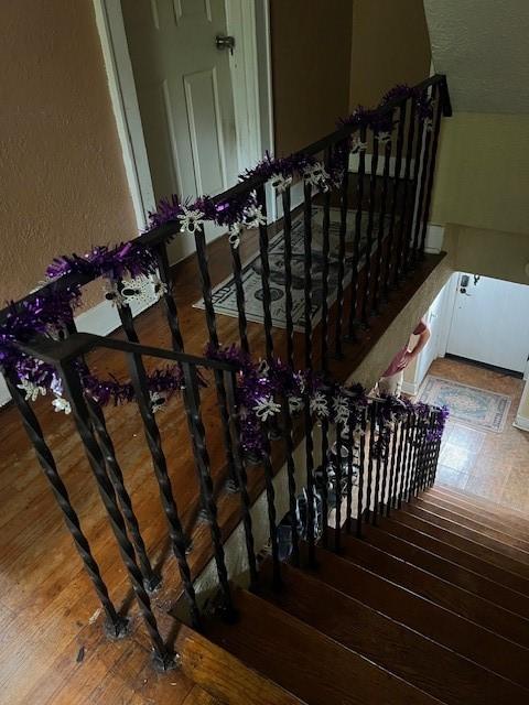 stairs featuring hardwood / wood-style floors