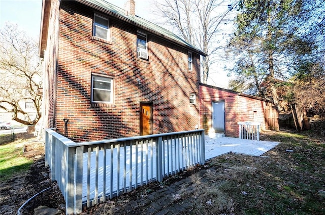 back of property featuring a patio area and a wooden deck