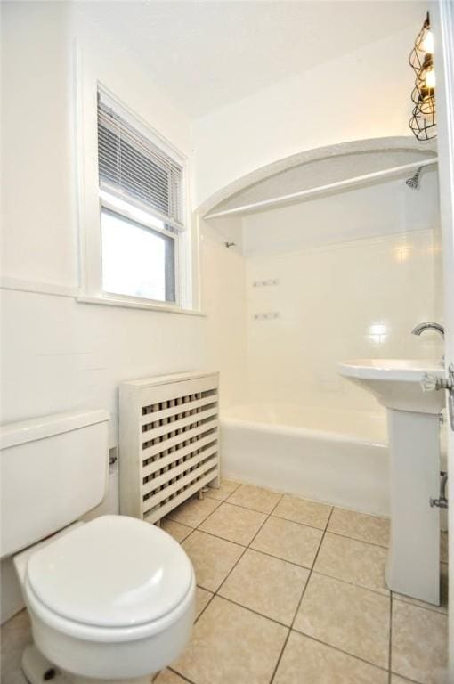 bathroom featuring tile patterned flooring, toilet, and radiator