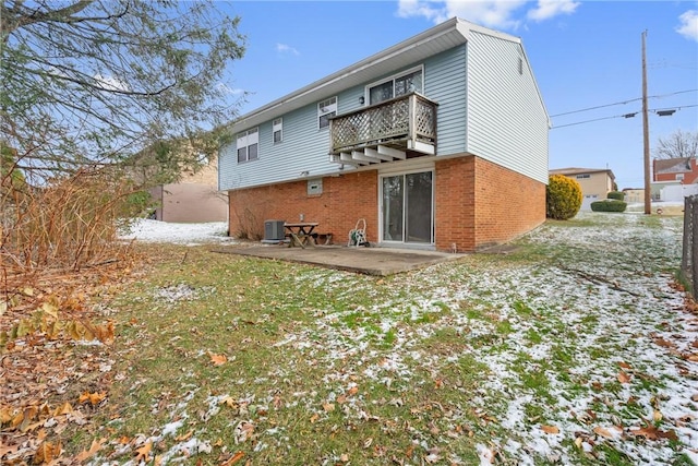 back of house featuring a lawn, a patio area, a balcony, and central air condition unit