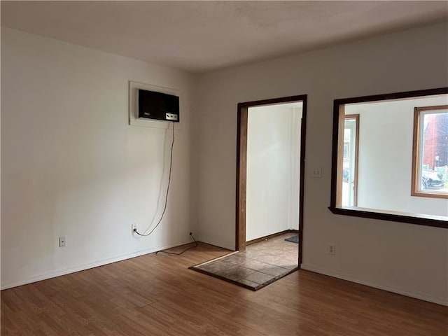 unfurnished room with hardwood / wood-style floors