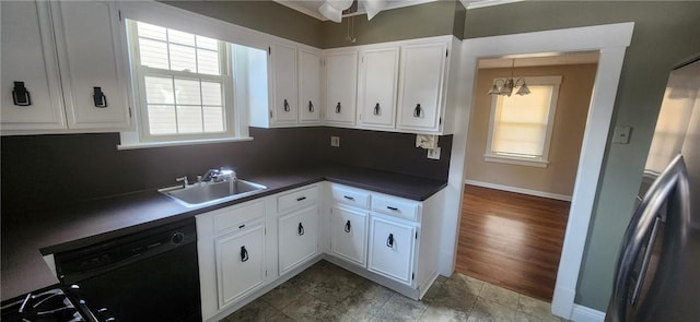 kitchen featuring sink, dark wood-type flooring, black dishwasher, white cabinets, and ceiling fan with notable chandelier