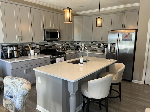 kitchen with decorative backsplash, stainless steel appliances, sink, dark hardwood / wood-style floors, and hanging light fixtures