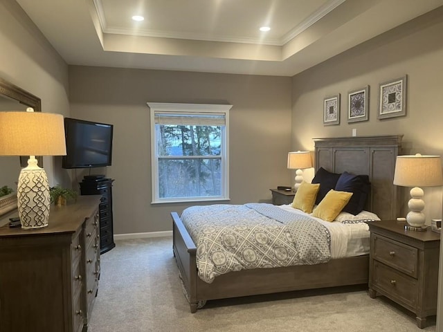 carpeted bedroom featuring a raised ceiling and ornamental molding