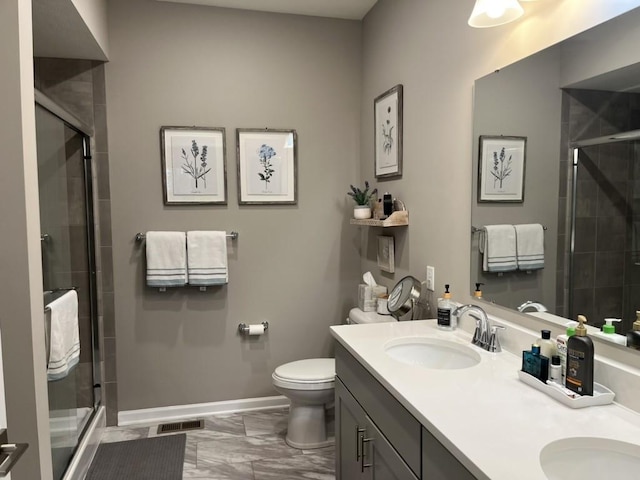 bathroom with vanity, toilet, and an enclosed shower