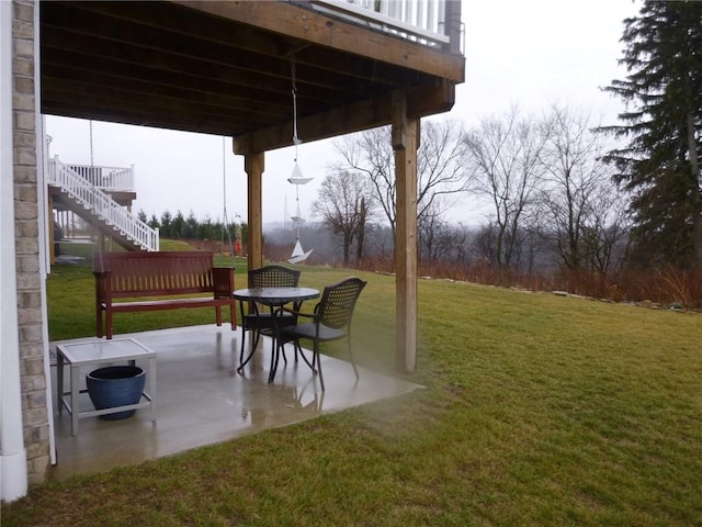 view of yard featuring a patio area and a wooden deck