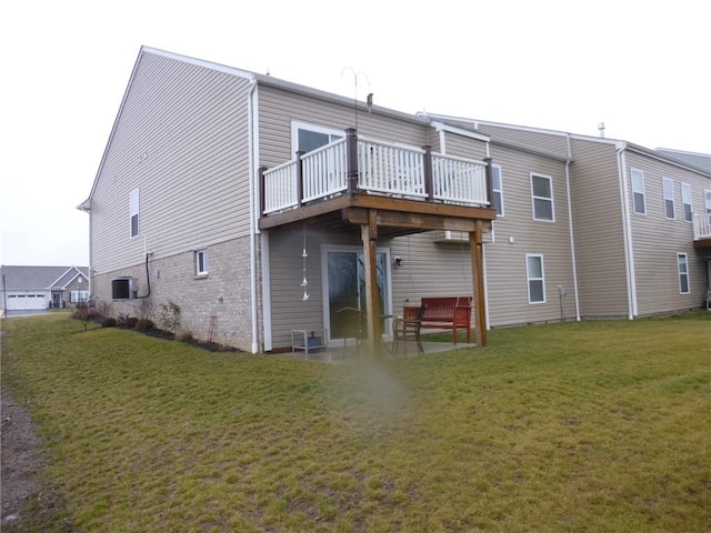 rear view of house featuring a patio, a deck, and a lawn