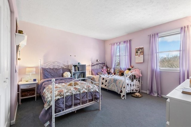 carpeted bedroom with multiple windows and a textured ceiling