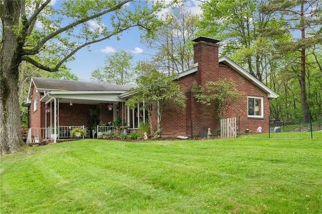 rear view of property with a yard