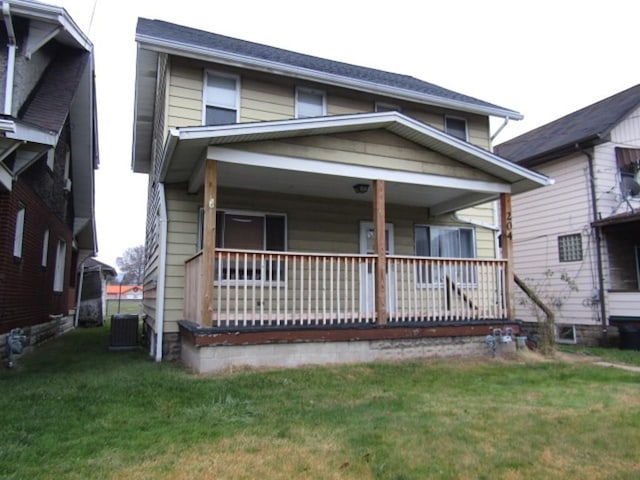 view of front of home with a front yard, covered porch, and central air condition unit