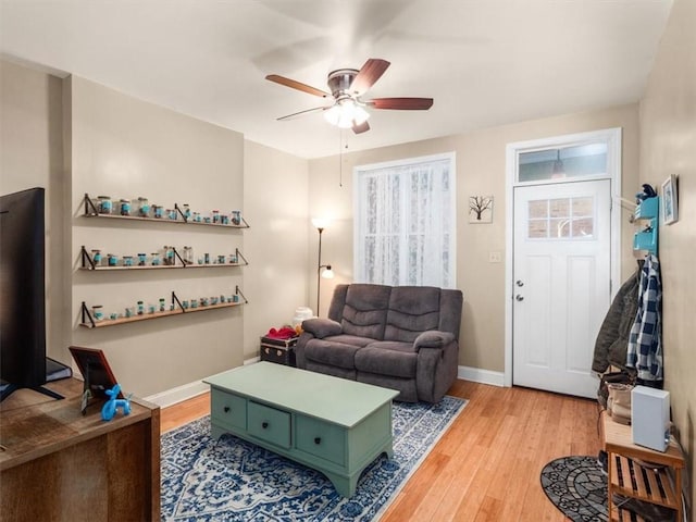 living room featuring wood-type flooring and ceiling fan