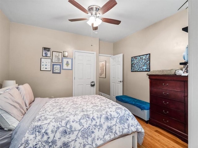 bedroom with ceiling fan and light hardwood / wood-style floors