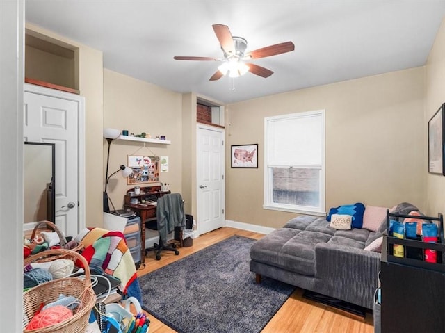 living room featuring hardwood / wood-style floors and ceiling fan