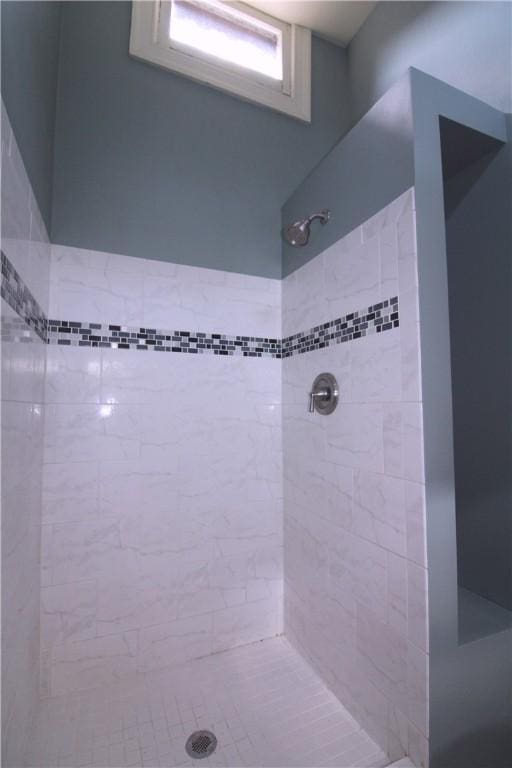 bathroom with a tile shower