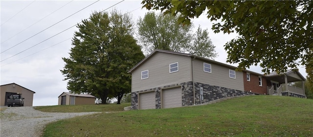 view of property exterior featuring a lawn and a garage