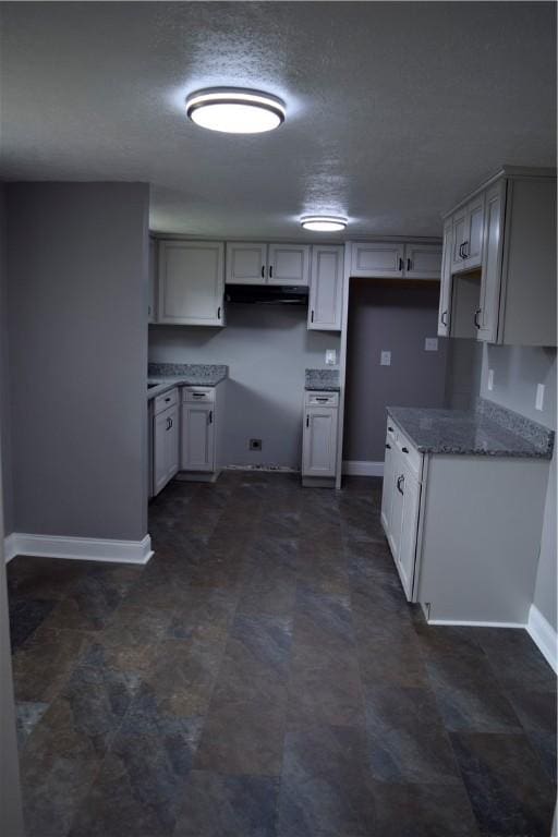 kitchen featuring white cabinetry and stone countertops