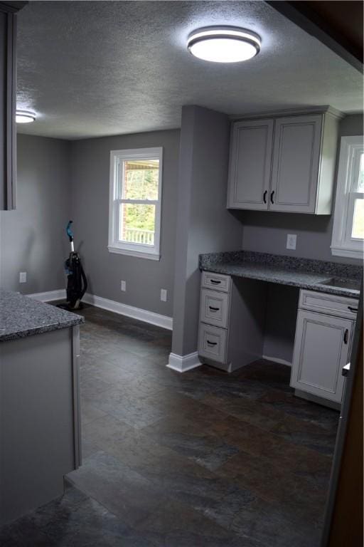 kitchen featuring white cabinets and a textured ceiling