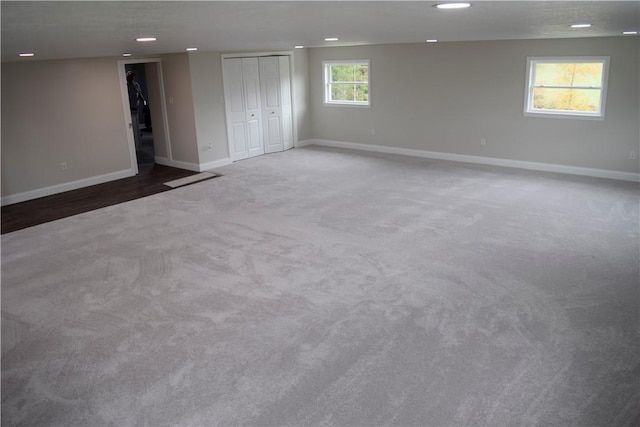 carpeted empty room featuring a textured ceiling and a wealth of natural light