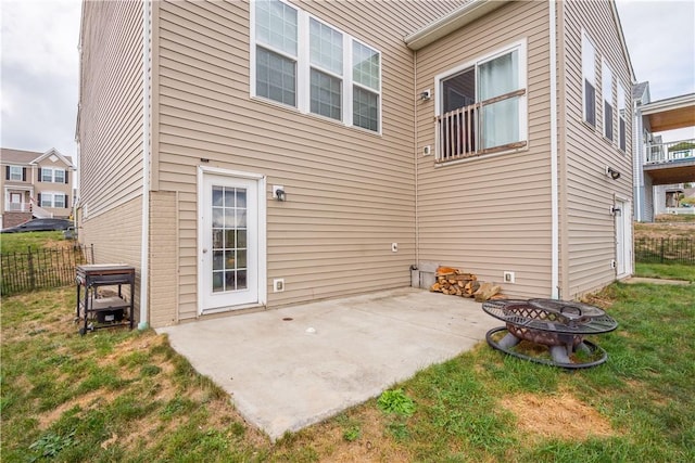 back of house with a patio, an outdoor fire pit, and a lawn