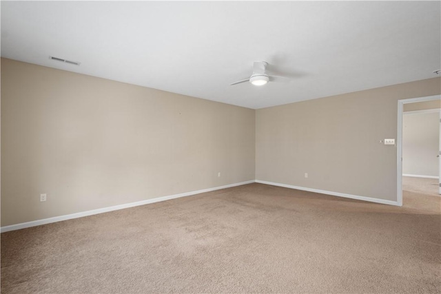 carpeted spare room with ceiling fan