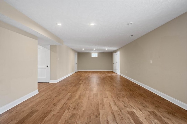 interior space with a textured ceiling and light wood-type flooring