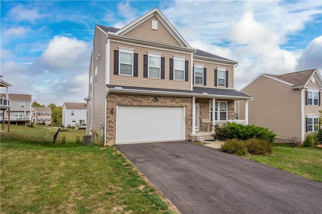 view of front of home featuring a garage and a front lawn