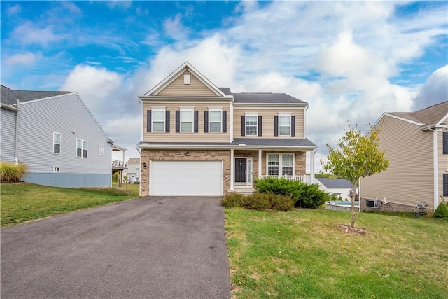 view of front of house featuring a garage and a front yard