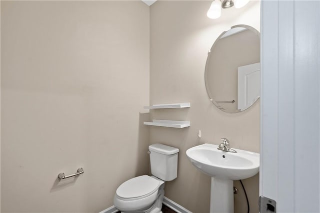 bathroom featuring sink and toilet