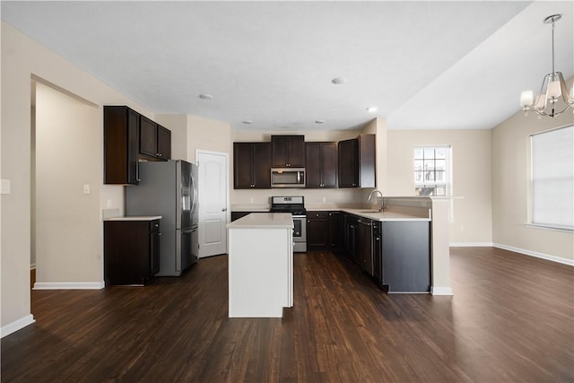 kitchen with dark brown cabinetry, hanging light fixtures, stainless steel appliances, dark hardwood / wood-style flooring, and a chandelier