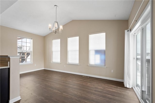 unfurnished living room featuring a notable chandelier, dark wood-type flooring, and vaulted ceiling