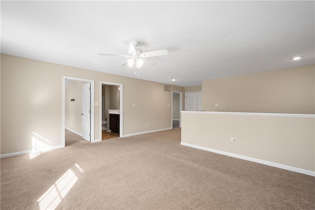 unfurnished room with light carpet and ceiling fan