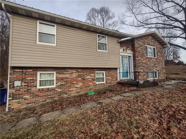 back of house with brick siding