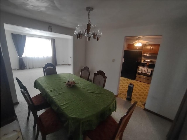 dining area with carpet and a notable chandelier