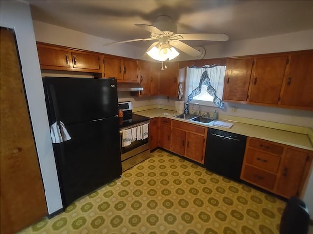 kitchen with a sink, black appliances, brown cabinetry, and light countertops