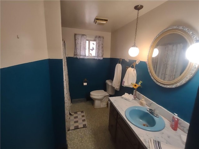 full bathroom featuring toilet, visible vents, and vanity