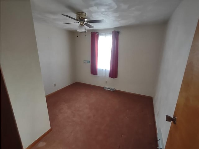 unfurnished room featuring a ceiling fan, carpet, visible vents, and baseboards