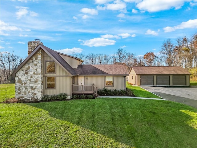 view of front of house featuring a garage, an outdoor structure, and a front yard