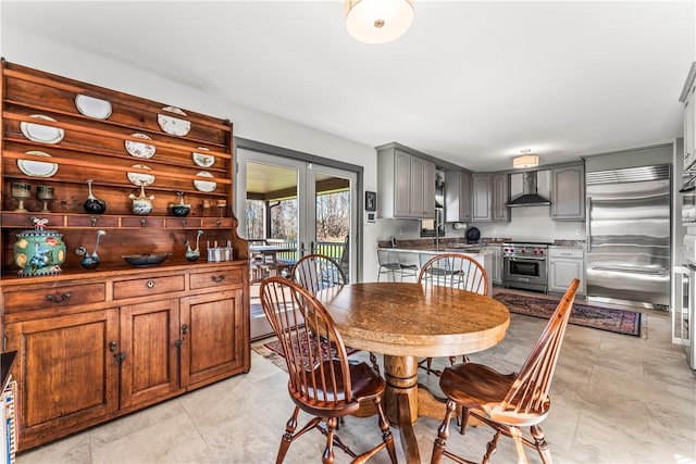 dining area featuring sink and french doors