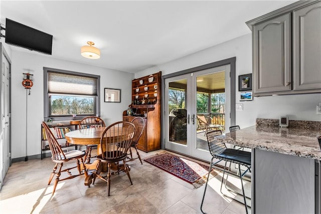 dining space with french doors and a healthy amount of sunlight