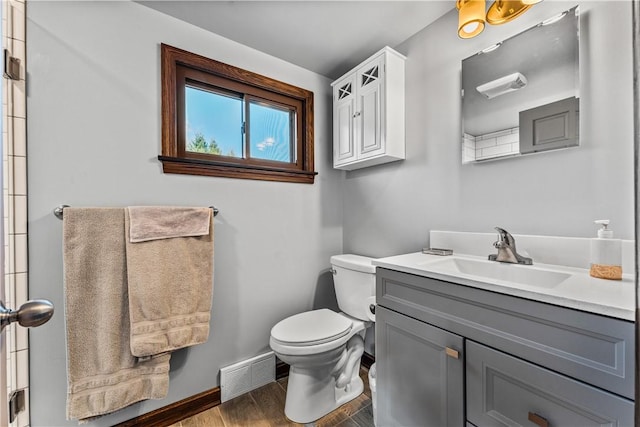 bathroom with vanity, hardwood / wood-style flooring, and toilet