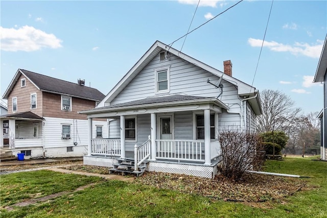 bungalow-style house featuring a front lawn and covered porch