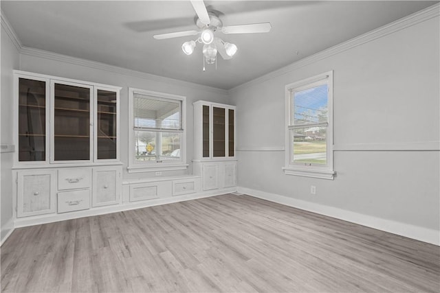 unfurnished room featuring ceiling fan, light hardwood / wood-style floors, and crown molding