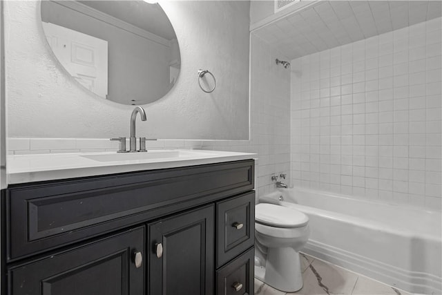 full bathroom featuring tiled shower / bath combo, toilet, and vanity