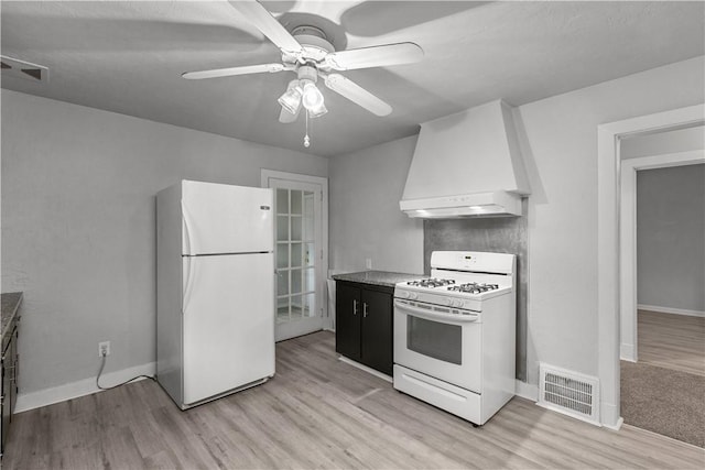 kitchen with premium range hood, white appliances, and light wood-type flooring