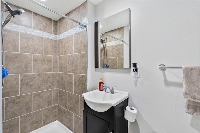 bathroom with vanity and tiled shower