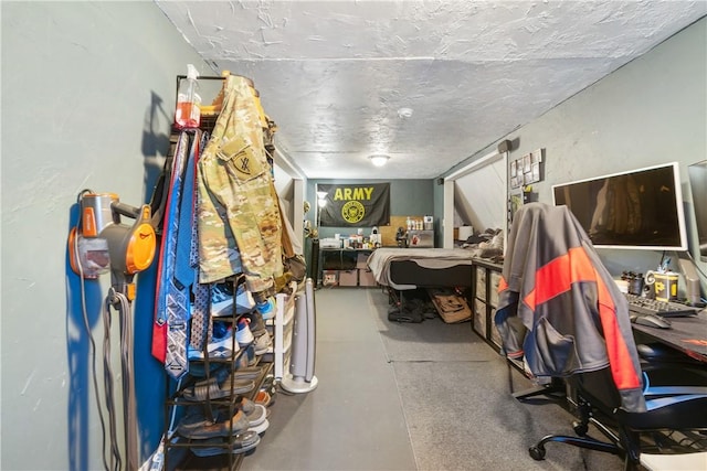 bedroom with a textured ceiling and concrete floors