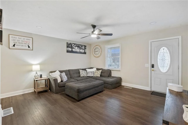 living room featuring ceiling fan and dark wood-type flooring