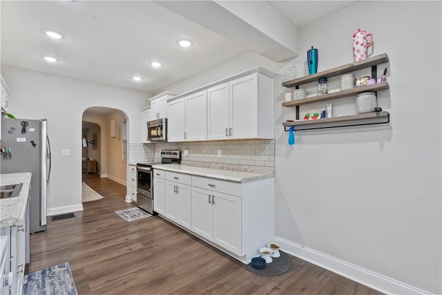 kitchen featuring white cabinets, dark wood-type flooring, and appliances with stainless steel finishes